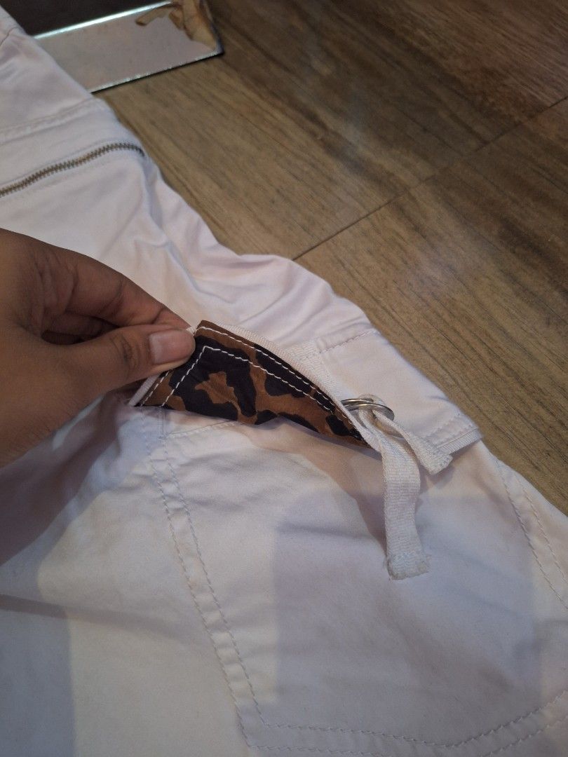 Caché White Cargo Pants Size 14 (Category: Jeans) located in Balamban. Submitted by ubethan (Listing ID 1469459646, Image 3). Description: Waist: 39 in" Length: 38 in" - Brand/Model: Caché White Cargo Pants - Size: 14 - Material: Shell (98% cotton, 2% spandex), Combo (94% polyester, 6% spandex) - Features: Multiple zip pockets, side cargo pockets with D-ring straps, and hidden leopard print accent lining inside the flap - Condition: Good, with a 