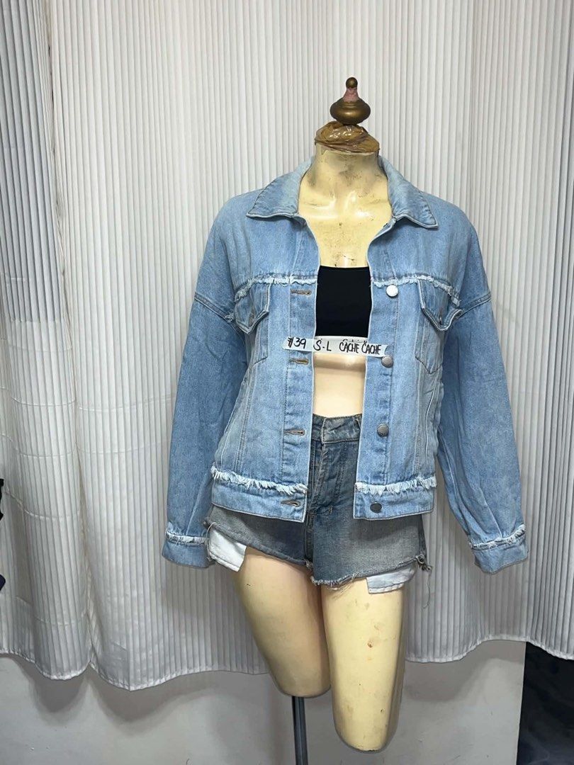 Cache Cache Light Wash Distressed Denim Jacket S-L (Category: Coats, Jackets and Outerwear) located in General Trias. Submitted by crissy9053136 (Listing ID 1469444318, Image 1). Description: - Brand: Cache Cache - Wash: Light denim with distressed frayed details on hem and pockets - Fit: Relaxed, slouchy fit (best fits Small to Large depending on preferred look) - Features: Button-up front, classic collar, metallic hardware, and dual chest pocke