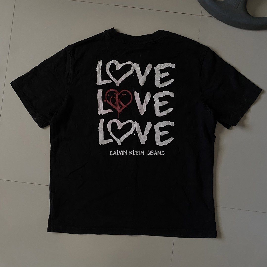 Calvin Klein Graphic tee (Category: Formal Shirts) located in Iligan City. Submitted by renzreyong66220 (Listing ID 1469444238, Image 2). Description: - Brand: Calvin Klein Jeans - Condition: Brand new with interior tags and care labels - Size: Medium - Color: Black - Front: Small Calvin logo print on the chest - Back: Large statement triple LOVE graphic print with ck branding - Sleeve: Small embroidered ck logo on the left sleeve - Neckline: Cre