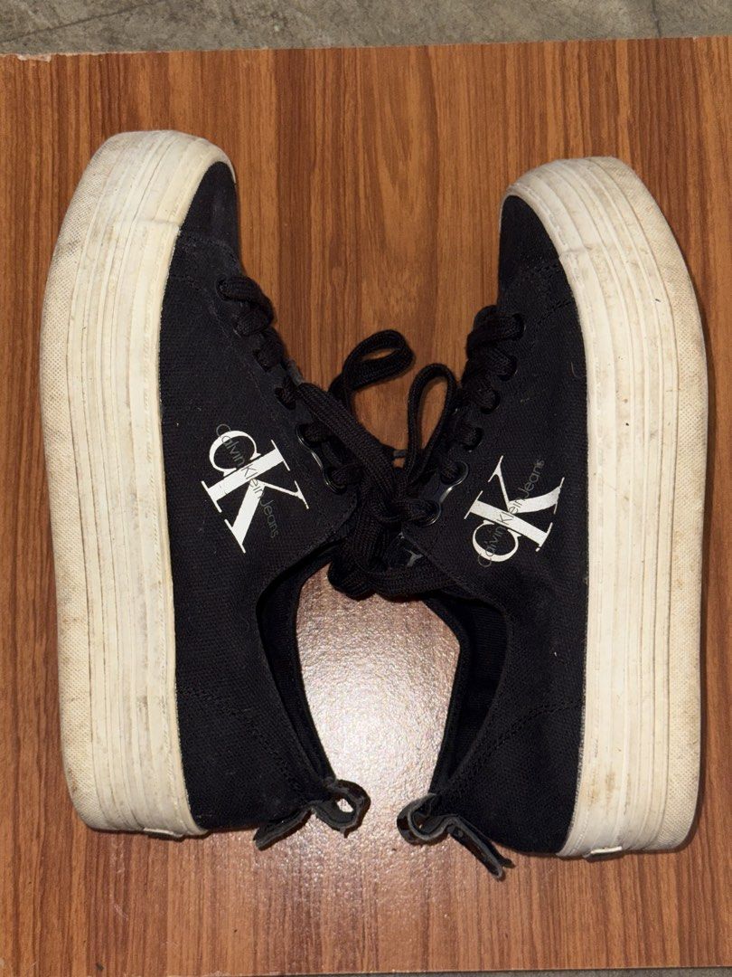 Calvin Klein Jeans black platform sneakers (Category: Sneakers) located in Batangas. Submitted by ystyledx (Listing ID 1469568255, Image 1). Description: - Brand: Calvin Klein Jeans - Style: Black canvas platform sneakers with chunky white soles - Details: White CK logo on the sides, black laces, and heel pull tabs - Condition: Minor scuffing on the platform soles - Fit: Comfortable for everyday wear.