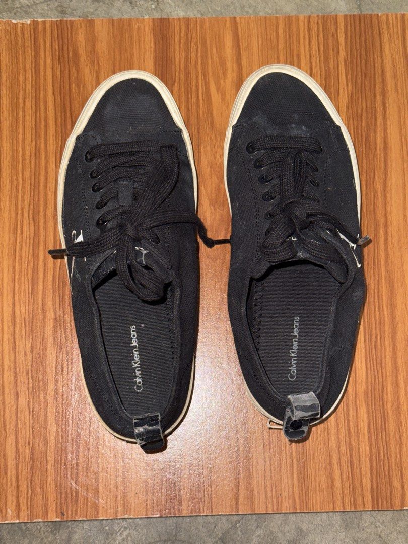 Calvin Klein Jeans black platform sneakers (Category: Sneakers) located in Batangas. Submitted by ystyledx (Listing ID 1469568255, Image 2). Description: - Brand: Calvin Klein Jeans - Style: Black canvas platform sneakers with chunky white soles - Details: White CK logo on the sides, black laces, and heel pull tabs - Condition: Minor scuffing on the platform soles - Fit: Comfortable for everyday wear.