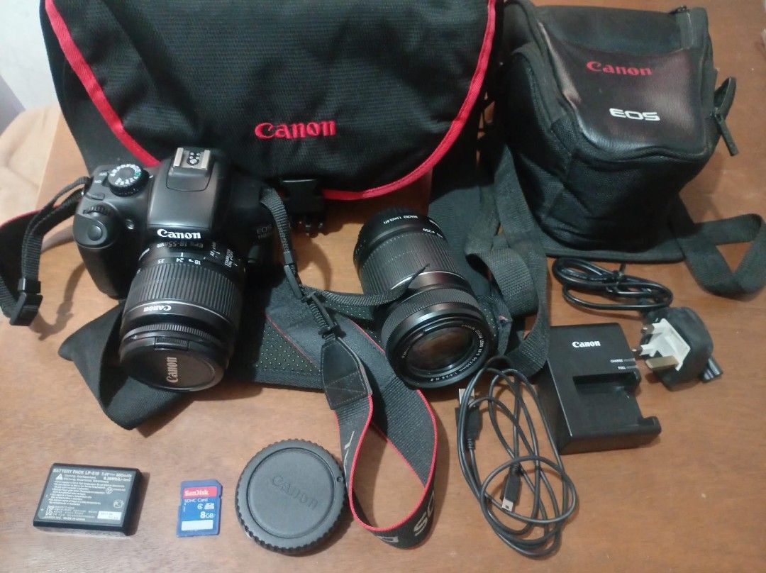 Canon EOS 1100D DSLR Camera with Two Lenses and Bag (Category: Cameras) located in Manila. Submitted by silentwhale_fe03d1 (Listing ID 1469432020, Image 2). Description: Canon EOS 1100D DSLR setup. Includes EF-S 18-55mm IS II lens and EF 55-250mm IS II telephoto lens. Canon camera strap attached. Battery pack LP-E10 and battery charger included. SanDisk 8GB SDHC memory card. USB data cable. Two Canon carrying bags provided. Everything ready for p
