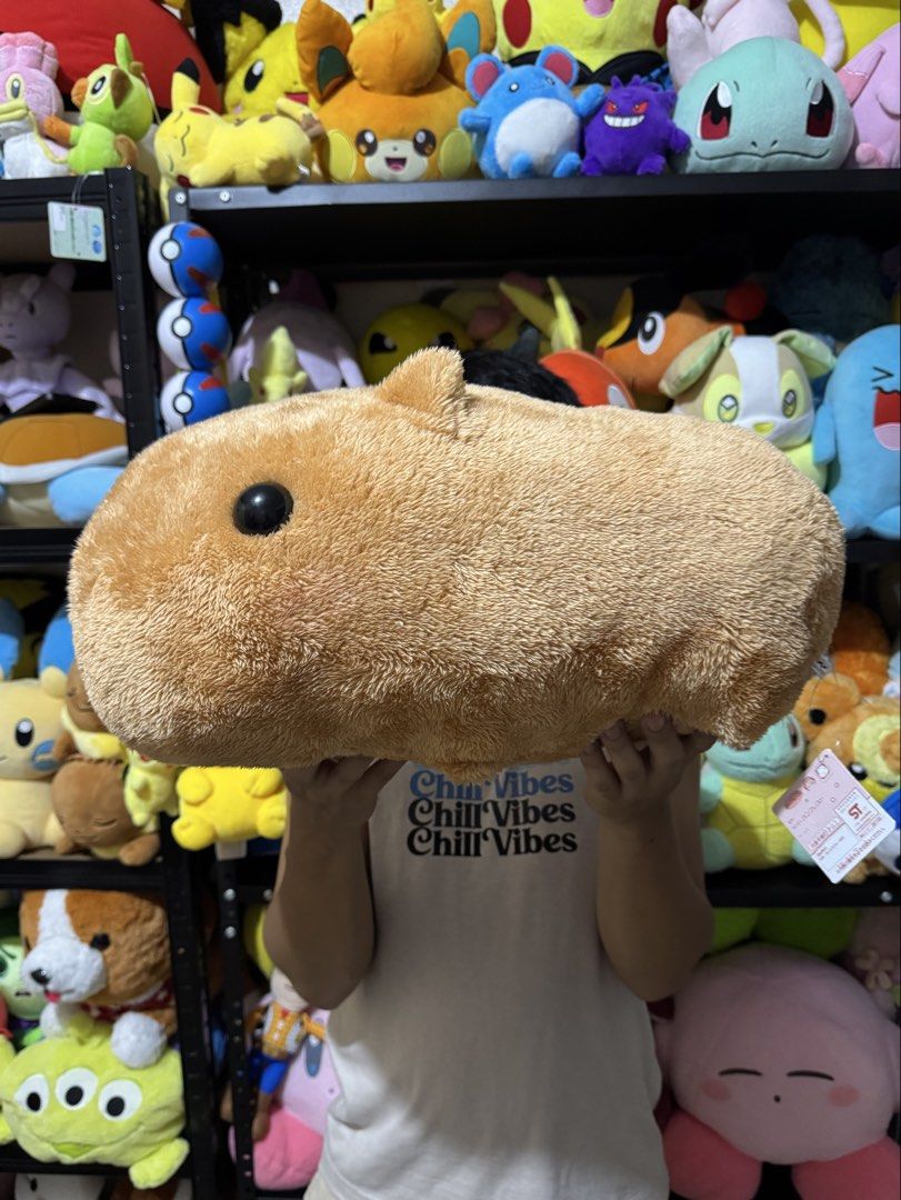 Capybara plush toy stuffed animal pillow (Category: Plushies & Soft Toys) located in Cainta. Submitted by mayhroeen (Listing ID 1469487826, Image 1). Description: - Large capybara plush toy with soft brown fur - Features cute stitched face details and compact ears - Very huggable size, perfect as a cushion or cuddle buddy - Brand new with tag still attached on the side - Clean and fluffy texture all around.