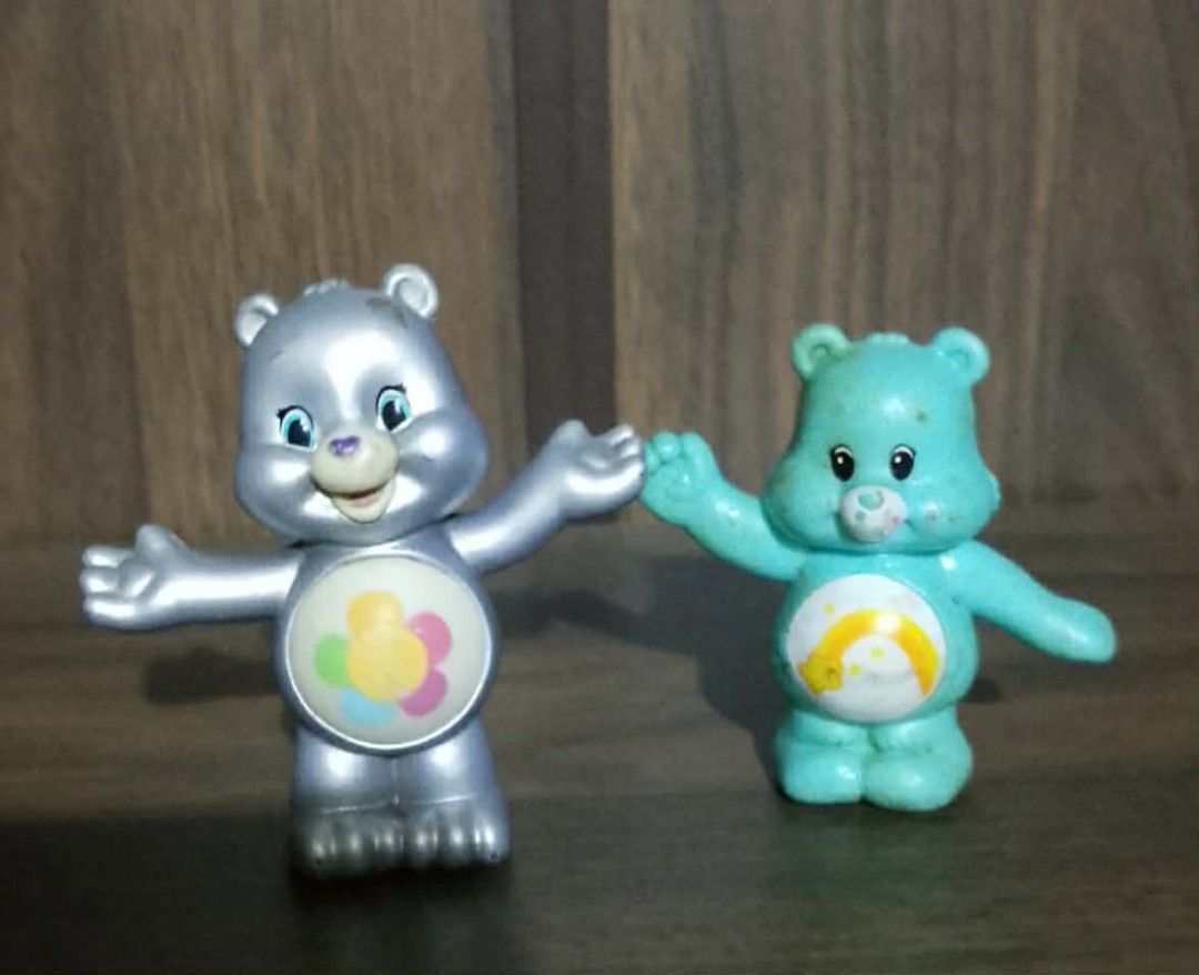 Care Bears Figures Lot - Silver and Turquoise (Category: Designer & Blind Box Toys) located in Paranaque City. Submitted by b_spilner (Listing ID 1469479018, Image 1). Description: - Set of 2 plastic Care Bears mini figures - Includes: Silver bear (flower belly badge) and Turquoise bear (shooting star belly badge) - Pose: Both have arms raised - Condition: Surface wear and paint scuffs present from regular play - Perfect for Care Bears collectors