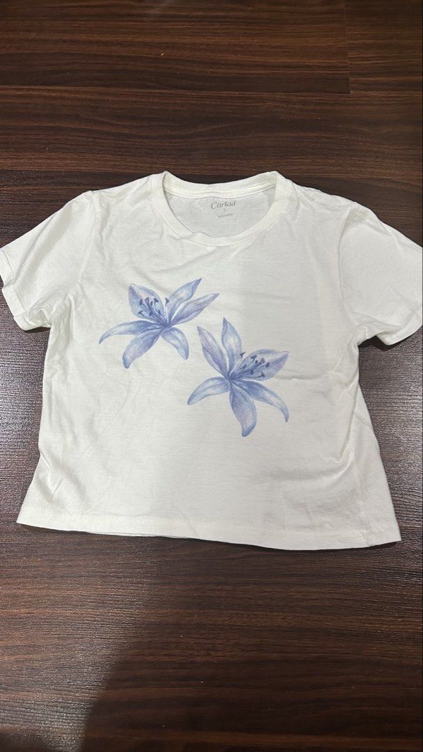 Cariad Baby Tee (Category: Shirts) located in Manila. Submitted by wengobaco (Listing ID 1469547506, Image 1). Description: Cariad blue flower baby tee Size small Has black stain at the back (lower left; see last pic) rfs: decluttering Loc: QC MOP: GCash only MOD: Lalamove/Grab (buyer will book and shoulder df).