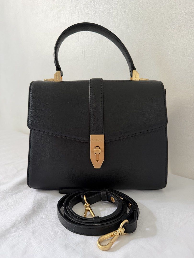 Carlyn Dear Black Bag (Category: Luxury Bags & Wallets) located in Manila. Submitted by meldydsant58389 (Listing ID 1469432008, Image 1). Description: - Brand: Carlyn - Color: Classic black with elegant gold-tone hardware - Closure: Secure front lock closure - Straps: Includes a single top handle and a detachable, adjustable shoulder strap - Condition: Like New. Clean sides and base - Capacity: Sleek everyday bag that easily fits your daily essen