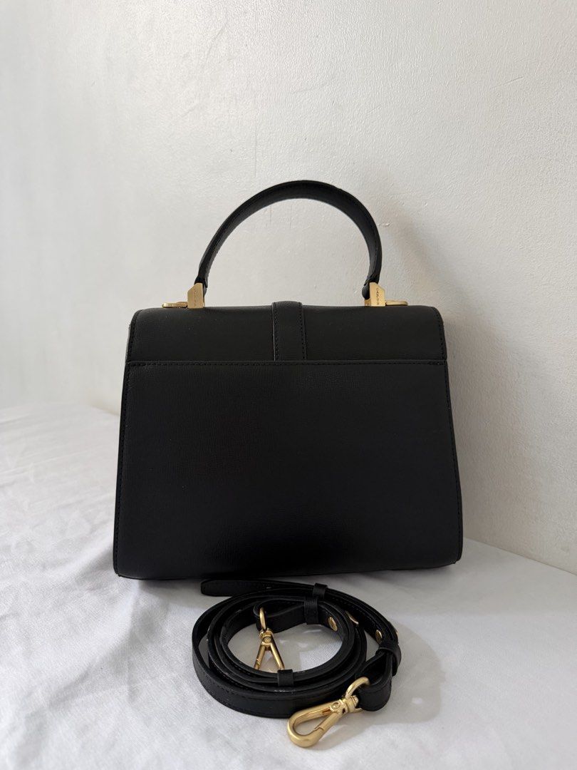 Carlyn Dear Black Bag (Category: Luxury Bags & Wallets) located in Manila. Submitted by meldydsant58389 (Listing ID 1469432008, Image 2). Description: - Brand: Carlyn - Color: Classic black with elegant gold-tone hardware - Closure: Secure front lock closure - Straps: Includes a single top handle and a detachable, adjustable shoulder strap - Condition: Like New. Clean sides and base - Capacity: Sleek everyday bag that easily fits your daily essen