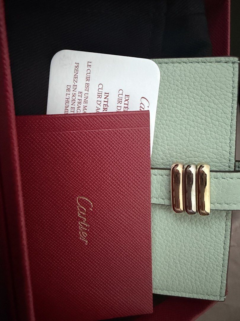 Cartier Trinity Cardholder Mint Green (Category: Luxury Bags & Wallets) located in Taal. Submitted by yanniyana (Listing ID 1469440100, Image 1). Description: - Brand: Cartier - Material: Mint green grained calfskin - Hardware: Iconic Trinity interlocking rings in yellow, white, and rose gold - Closure: Strap closure with Trinity detail - Use: Compact everyday luxury accessory for cards and cash - Inclusions: Original Cartier red presentation box