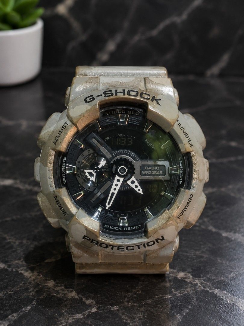 Casio G-Shock (Category: Men's Watches) located in Manila. Submitted by Decca0310 (Listing ID 1469472952, Image 1). Description: - Eye-catching full desert camouflage resin case and strap - Reliable analog and digital display with chronograph - Dark dial featuring sleek silver hands and hour markers - Tough build with prominent bezel guards for extra durability - 20BAR / 200M water resistance rating for swimming and diving - Secure standard buckl