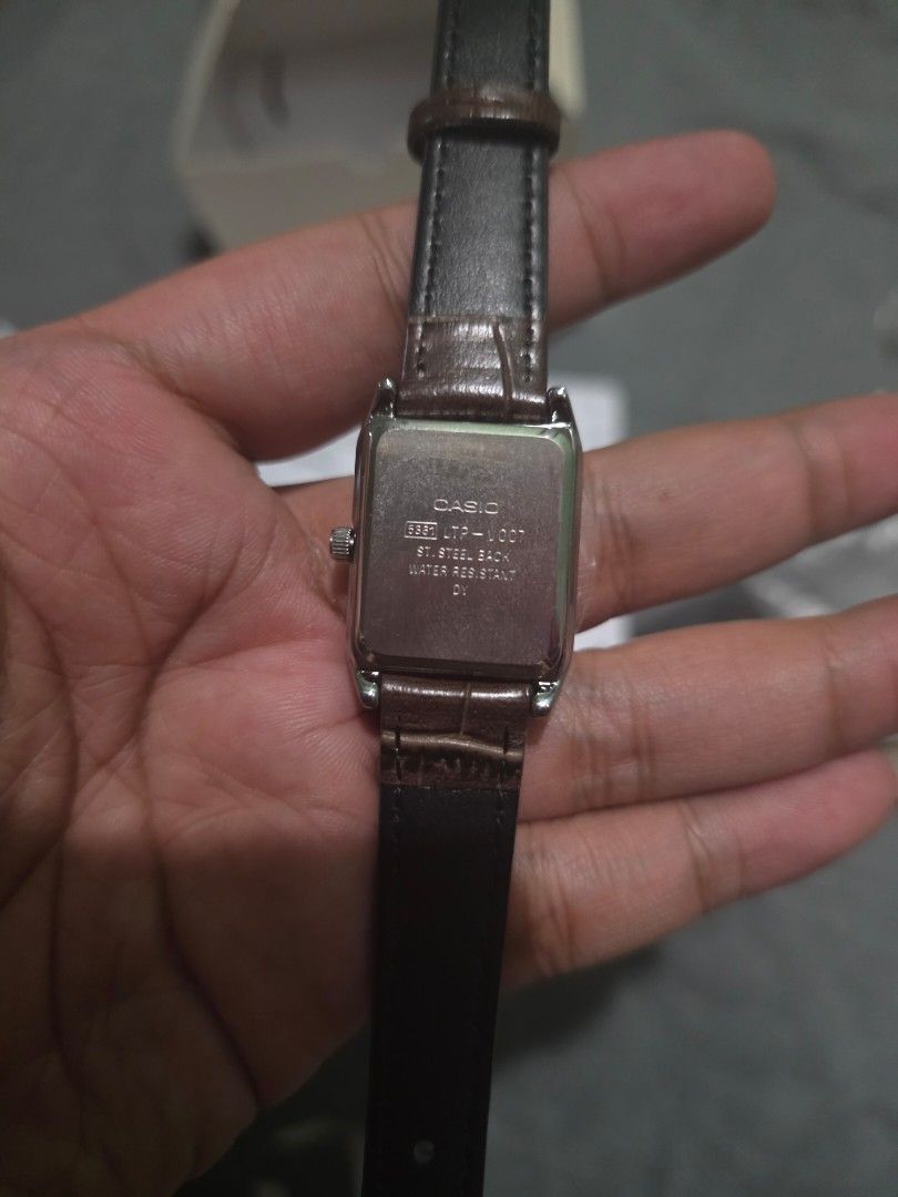 Casio LTP-V007 Rectangular Roman Numeral Watch (Category: Women's Watches) located in Manila. Submitted by biiiiiilllyyy (Listing ID 1469517199, Image 2). Description: - Model: Casio LTP-V007 women's watch - Condition: Brand new with protective plastic film on the crystal - Design: Rectangular silver-tone case with a white dial and classic Roman numerals - Strap: Brown leather strap with a stylish croc texture - Features: Water-resistant back - I