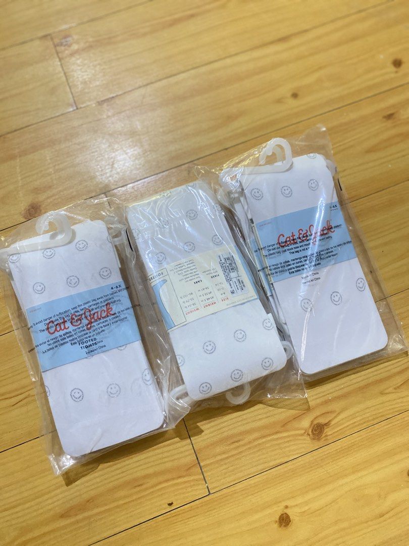 Cat & Jack White Glitter Smiley Face Tights 3 Pack (Category: Babies & Kids Fashion) located in Batangas. Submitted by lux_kimmy (Listing ID 1469421213, Image 3). Description: - Quantity: 3 packs of white footed tights - Design: All-over silver glitter smiley face print - Size: 4-6X - Material: 85% nylon, 15% spandex (machine washable) - Condition: Brand new, still sealed in original plastic packaging with hangers 99 each.