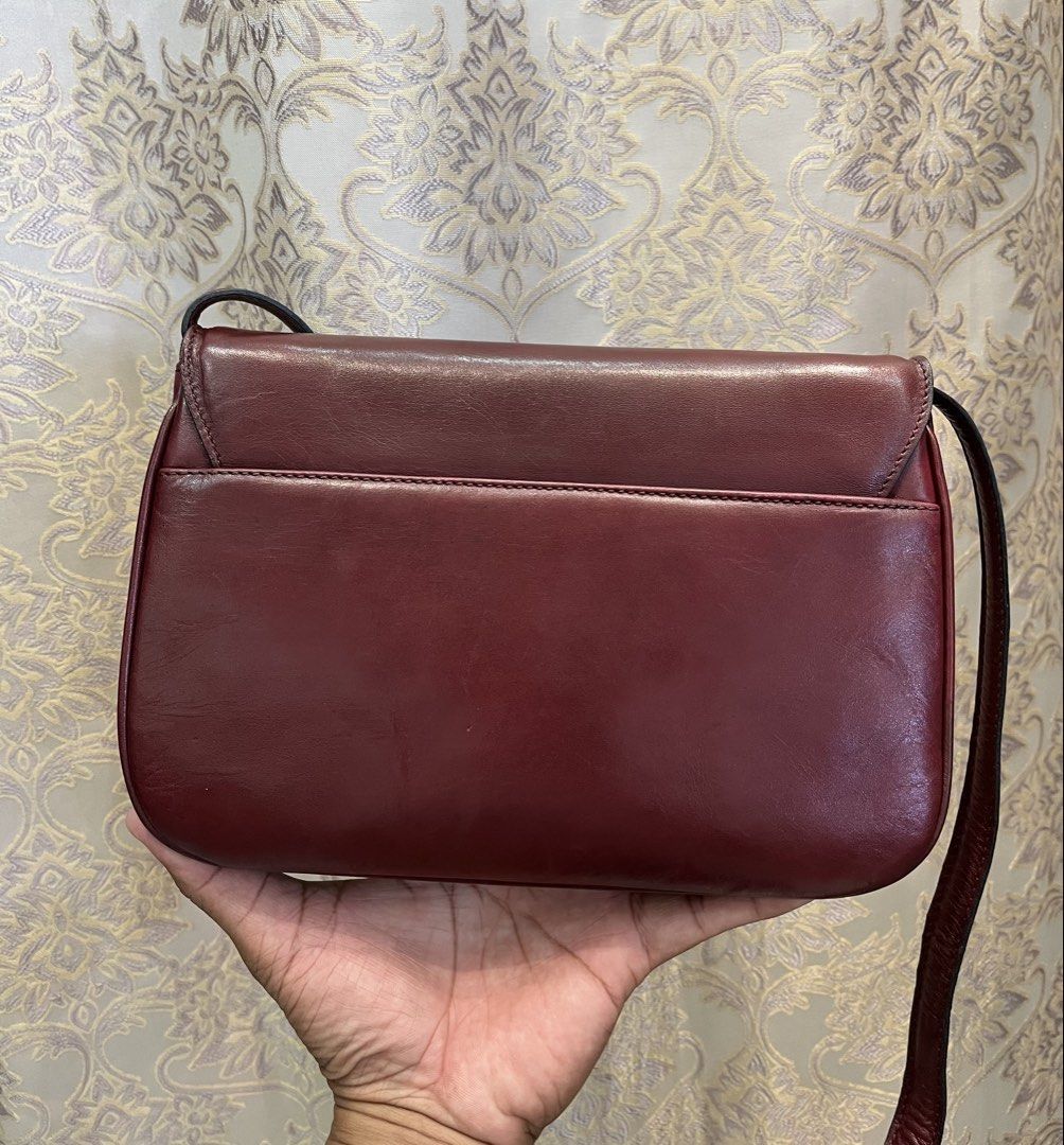 Celine Burgundy Leather Shoulder Bag (Category: Luxury Bags & Wallets) located in General Santos City (Dadiangas). Submitted by thiftnibadi3 (Listing ID 1469444796, Image 3). Description: - Authentic Celine crossbody bag in a rich burgundy leather - Elegant gold-tone hardware and front clasp closure - Structured accordion design with multiple interior compartments and a zippered pocket - Classic tan leather interior lining - Adjustable shoulder s