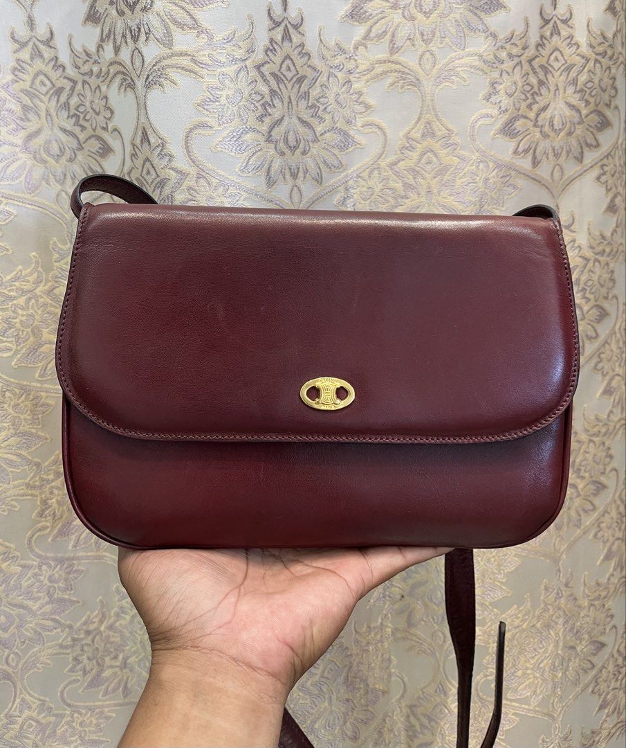 Celine Burgundy Leather Shoulder Bag (Category: Luxury Bags & Wallets) located in General Santos City (Dadiangas). Submitted by thiftnibadi3 (Listing ID 1469444796, Image 1). Description: - Authentic Celine crossbody bag in a rich burgundy leather - Elegant gold-tone hardware and front clasp closure - Structured accordion design with multiple interior compartments and a zippered pocket - Classic tan leather interior lining - Adjustable shoulder s