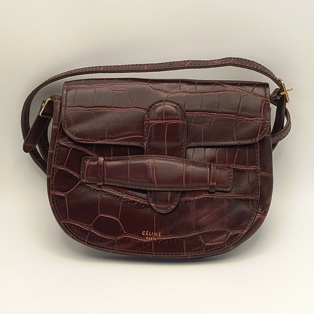 Celine Mini Symmetrical Bag Brown Croc (Category: Luxury Bags & Wallets) located in Lapu Lapu. Submitted by theluxxaffair (Listing ID 1469541156, Image 1). Description: Guaranteed authentic Celine Symmetrical Mini Bag in deep brown (walnut) crocodile-embossed leather. A compact structured crossbody silhouette featuring the signature symmetrical belt detail, gold-tone hardware, and a slim adjustable strap. Can be worn crossbody or converted into a