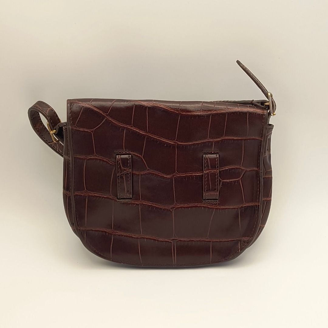 Celine Mini Symmetrical Bag Brown Croc (Category: Luxury Bags & Wallets) located in Lapu Lapu. Submitted by theluxxaffair (Listing ID 1469541156, Image 3). Description: Guaranteed authentic Celine Symmetrical Mini Bag in deep brown (walnut) crocodile-embossed leather. A compact structured crossbody silhouette featuring the signature symmetrical belt detail, gold-tone hardware, and a slim adjustable strap. Can be worn crossbody or converted into a