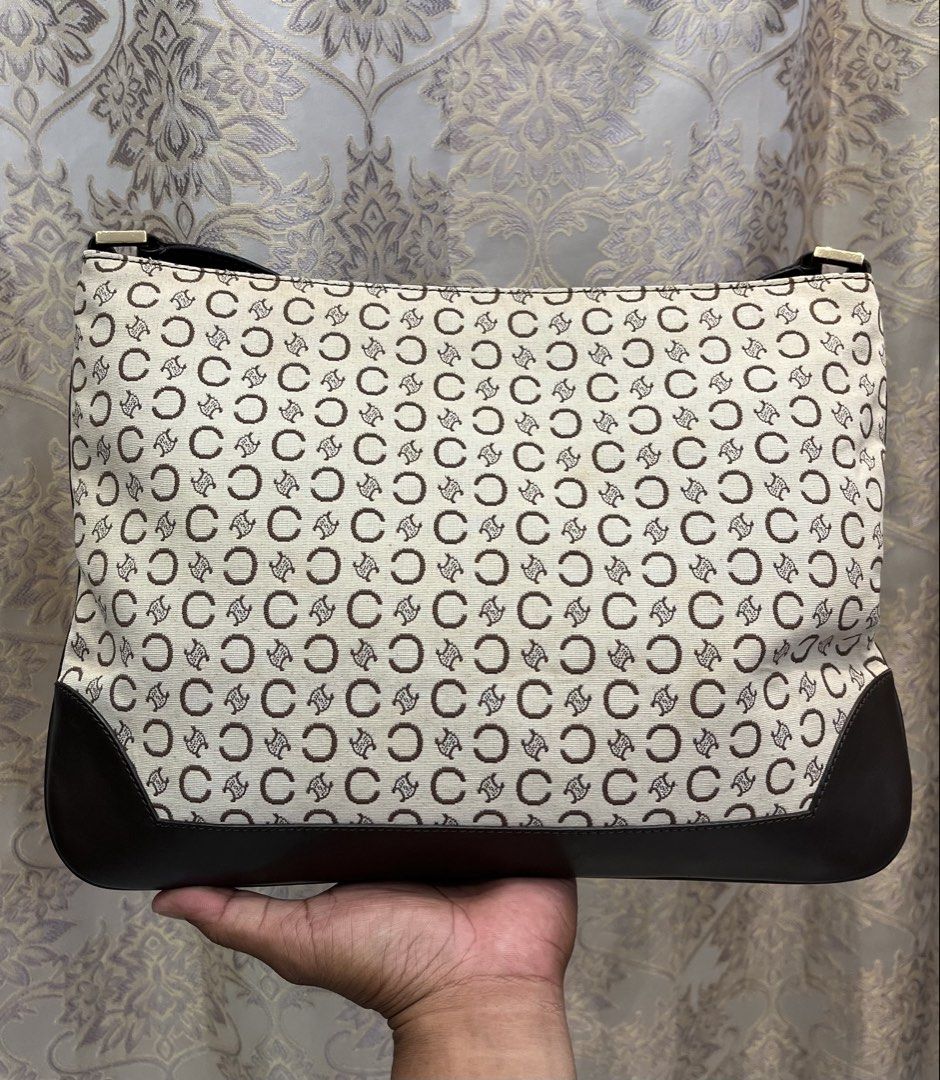 Celine Monogram Shoulder Bag (Category: Luxury Bags & Wallets) located in General Santos City (Dadiangas). Submitted by thiftnibadi3 (Listing ID 1469440127, Image 2). Description: - Authentic Celine shoulder bag - Cream and dark brown C monogram canvas with dark brown leather trim - Secure top zip closure with gold-tone Celine Paris hardware - Fabric-lined interior with all-over Celine branding - Made in Italy with serial number MC01/1 inside.