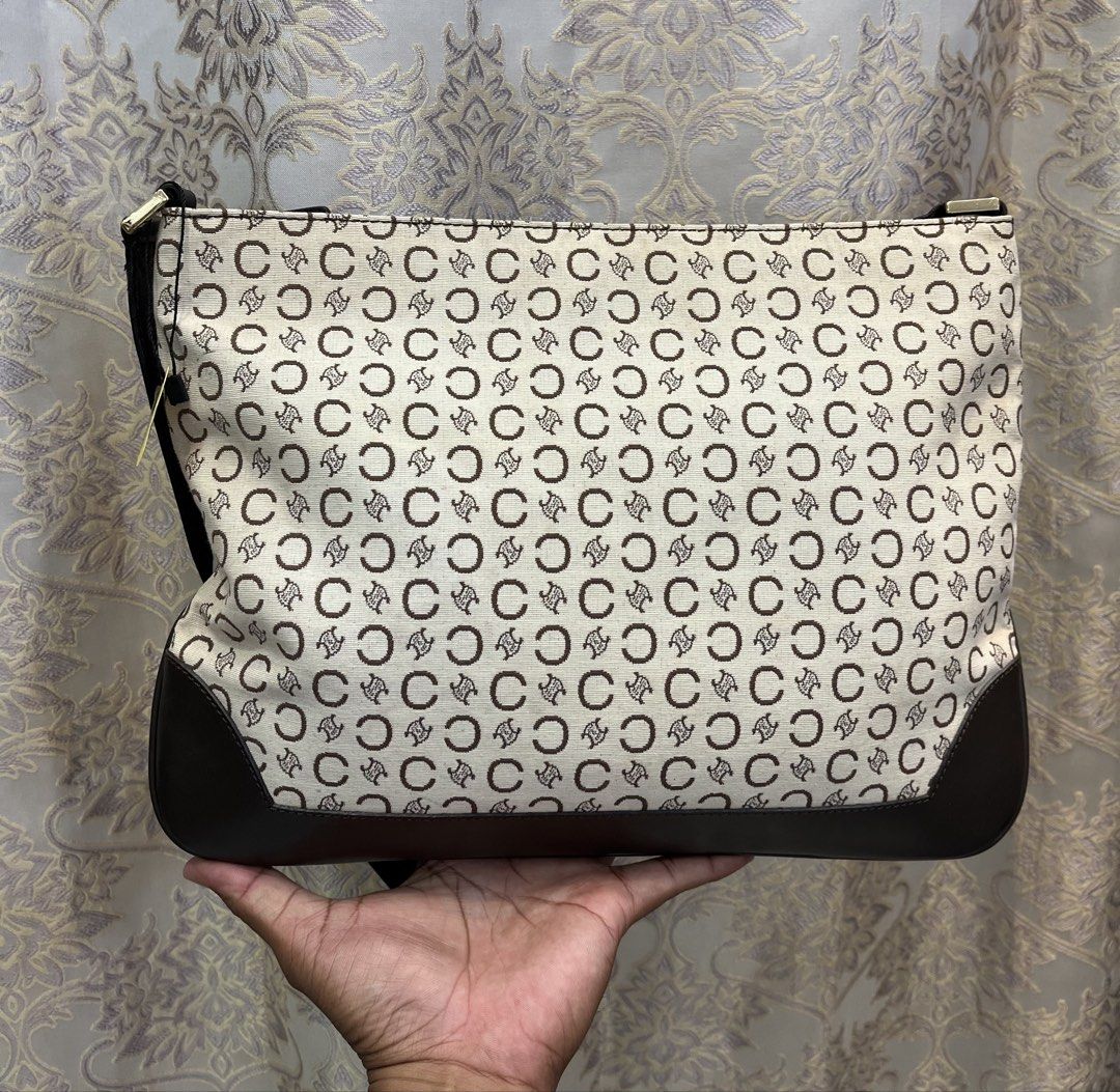 Celine Monogram Shoulder Bag (Category: Luxury Bags & Wallets) located in General Santos City (Dadiangas). Submitted by thiftnibadi3 (Listing ID 1469440127, Image 1). Description: - Authentic Celine shoulder bag - Cream and dark brown C monogram canvas with dark brown leather trim - Secure top zip closure with gold-tone Celine Paris hardware - Fabric-lined interior with all-over Celine branding - Made in Italy with serial number MC01/1 inside.