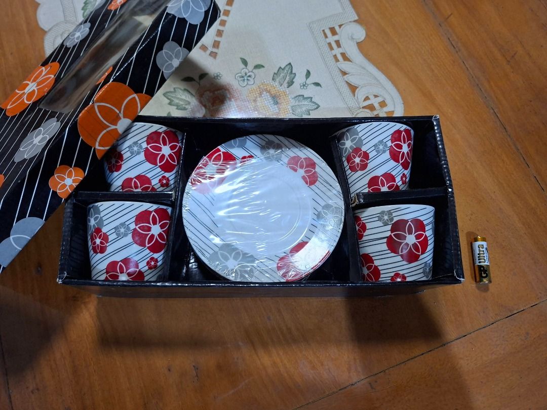 Ceramic Tea Cup and Saucer Set with Floral Pattern (Category: Coffee & Tea Tableware) located in Taguig. Submitted by d_man11 (Listing ID 1469459319, Image 2). Description: - Matching tea set with cups and saucers - Design: Elegant white ceramic with bold red & grey floral blossoms and modern black diagonal stripes - Condition: Unused, kept safely in storage, perfect condition, no cracks, no scratches - Packaging: Comes in its original gift box w