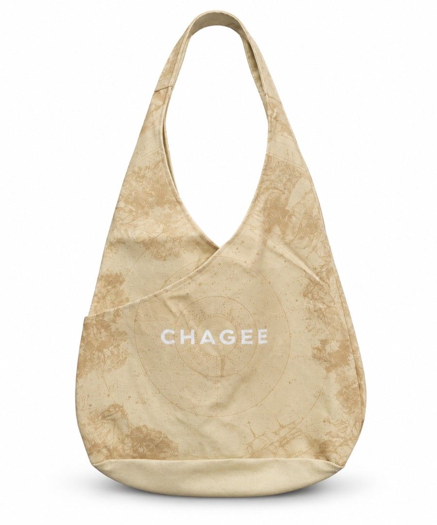 CHAGEE Canvas Hobo Slouchy Tote Bag (Category: Tote Bags) located in Pasig City. Submitted by swipeandpicks (Listing ID 1469507003, Image 1). Description: • Style: Slouchy Hobo / Crescent Shoulder Bag / Tote Bag • Color: Cream / Natural Beige base with muted light-brown/tan floral map and compass graphics. Crisp white printed "CHAGEE" logo. • Material: High-quality, durable cotton canvas (Thick and sturdy, not flimsy) • Features: One main open co
