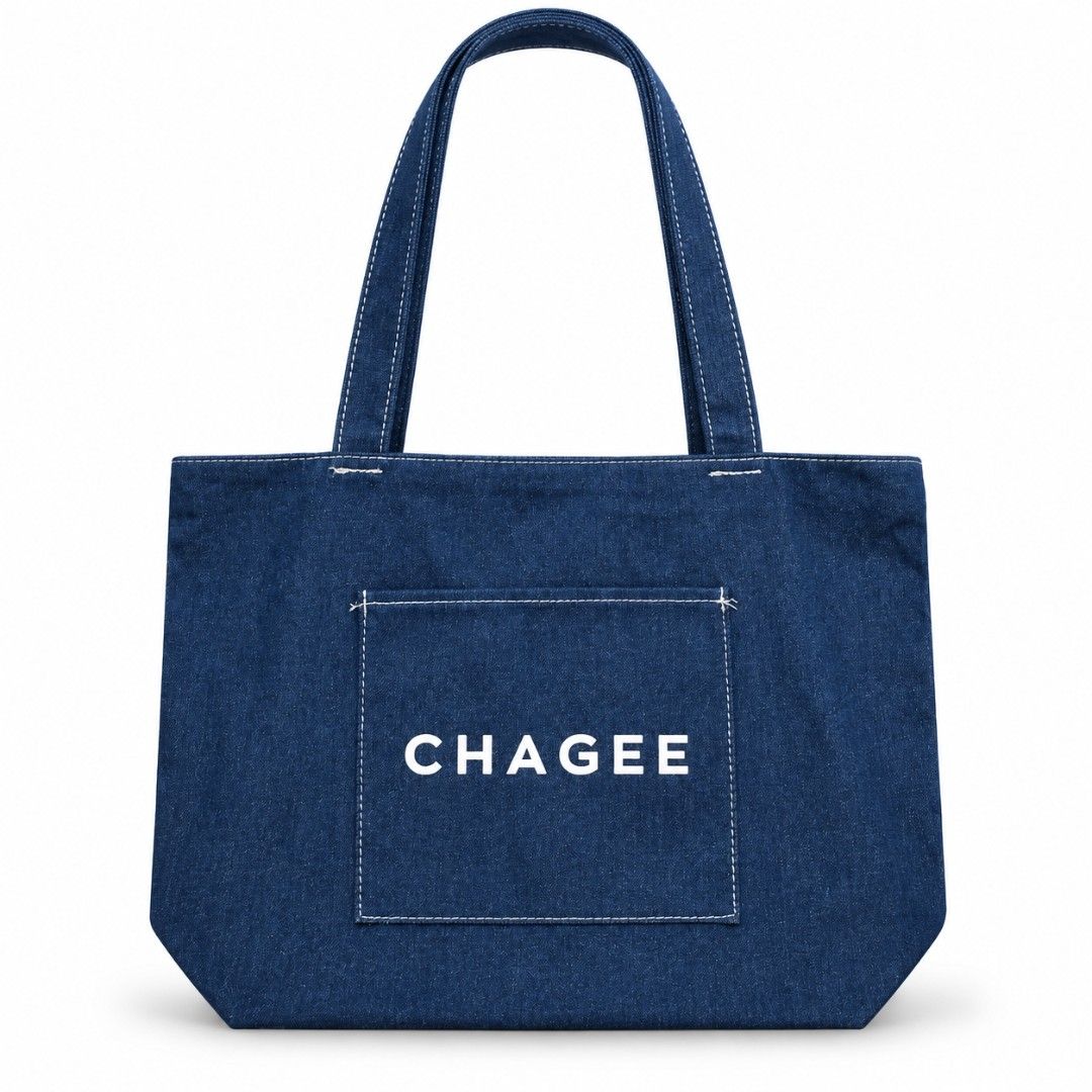 CHAGEE Denim Tote Bag (Category: Tote Bags) located in Pasig City. Submitted by swipeandpicks (Listing ID 1469514220, Image 1). Description: •Material: High-quality, durable thick denim canvas fabric with neat contrast stitching. • Color: Deep Indigo Blue / Denim Blue with white embroidered branding. • Features: Spacious main compartment, front pocket for quick access (keys, phone, cards), and sturdy shoulder straps. • Size: L11.5*W16.5.