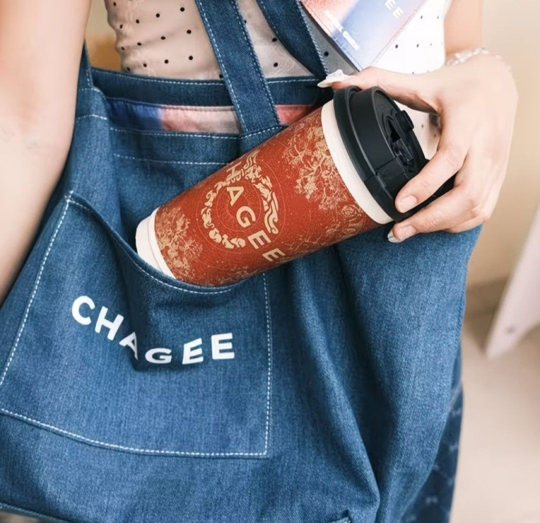 CHAGEE Denim Tote Bag (Category: Tote Bags) located in Pasig City. Submitted by swipeandpicks (Listing ID 1469514220, Image 3). Description: •Material: High-quality, durable thick denim canvas fabric with neat contrast stitching. • Color: Deep Indigo Blue / Denim Blue with white embroidered branding. • Features: Spacious main compartment, front pocket for quick access (keys, phone, cards), and sturdy shoulder straps. • Size: L11.5*W16.5.