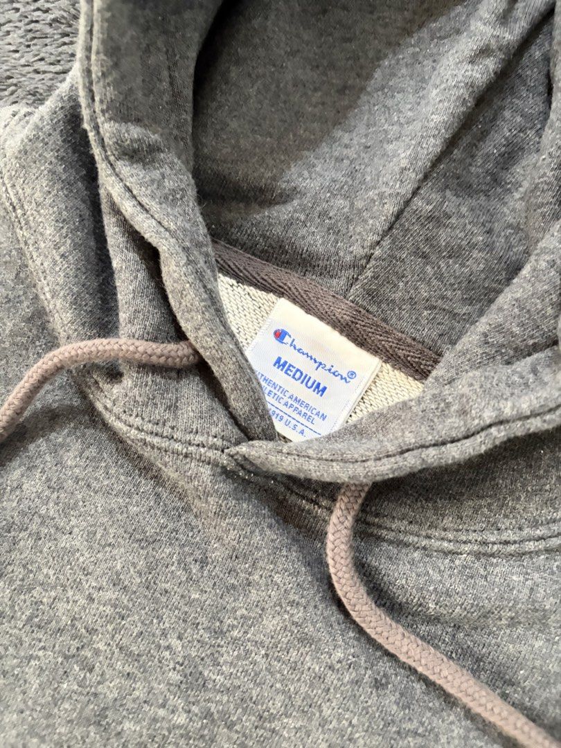 Champion Gray Hoodie Medium (Category: Hoodies) located in Quezon City. Submitted by marifavo (Listing ID 1469444971, Image 2). Description: - Brand: Champion - Color: Dark Gray - Size: Medium (tag inside collar) - Material: Soft fleece interior lining for maximum comfort - Details: Classic front kangaroo pocket, matching drawstring hood, and ribbed cuffs and hem - Branding: Embroidered Champion logo patch on the chest - Condition: Great everyday