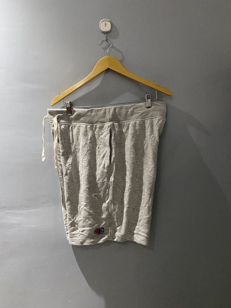 Champion Grey Sweatshorts Size Large (Category: Shorts) located in Bangued. Submitted by koroysthrifts (Listing ID 1469518342, Image 1). Description: - Brand: Champion 32-38x19.5x12.5 - Item: Fleece Sweatshorts - Size: Large (L) - Color: Grey with cream-colored adjustable drawstring cords - Pockets: Two side pockets and one back pocket - Details: Small embroidered Champion logo patch on the left hem - Material: Comfortable cotton blend, made in V