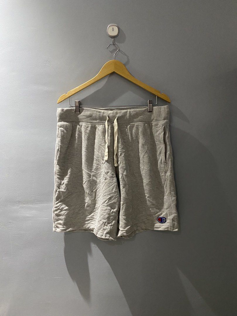 Champion Grey Sweatshorts Size Large (Category: Shorts) located in Bangued. Submitted by koroysthrifts (Listing ID 1469518342, Image 2). Description: - Brand: Champion 32-38x19.5x12.5 - Item: Fleece Sweatshorts - Size: Large (L) - Color: Grey with cream-colored adjustable drawstring cords - Pockets: Two side pockets and one back pocket - Details: Small embroidered Champion logo patch on the left hem - Material: Comfortable cotton blend, made in V