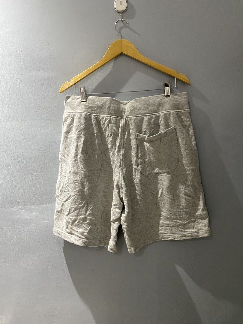 Champion Grey Sweatshorts Size Large (Category: Shorts) located in Bangued. Submitted by koroysthrifts (Listing ID 1469518342, Image 3). Description: - Brand: Champion 32-38x19.5x12.5 - Item: Fleece Sweatshorts - Size: Large (L) - Color: Grey with cream-colored adjustable drawstring cords - Pockets: Two side pockets and one back pocket - Details: Small embroidered Champion logo patch on the left hem - Material: Comfortable cotton blend, made in V