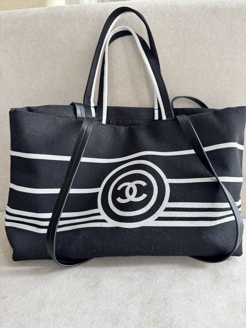 Chanel Black White Striped Canvas Tote Bag (Category: Tote Bags) located in Paranaque City. Submitted by piemumbuys (Listing ID 1469464704, Image 1). Description: - Authentic black and white canvas Chanel tote bag with striking front CC circle graphic - Dual carrying handles accented with premium leather straps - Spacious black fabric interior lining with a secure zippered pocket - Includes interior Chanel fabric tag, leather embossed logo tag, a