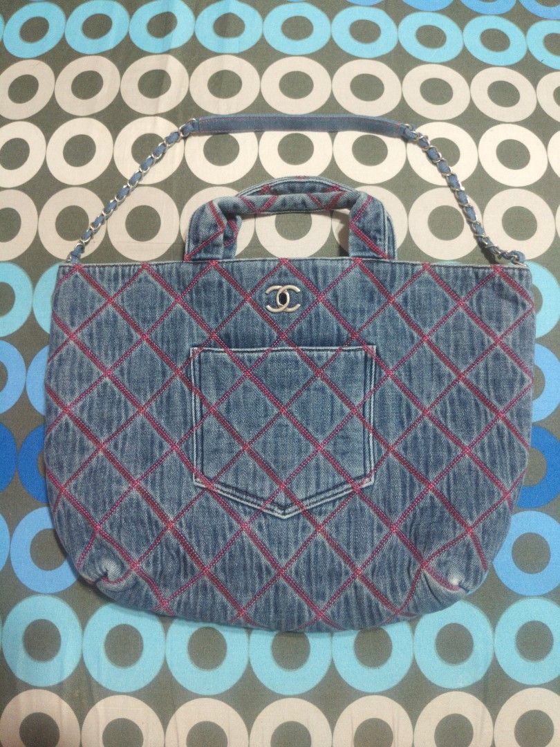 Chanel Denim Quilted Tote Bag with Chain Strap (Category: Tote Bags) located in San Mateo. Submitted by roxyj120919 (Listing ID 1469488308, Image 1). Description: Blue denim tote bag with pink diamond stitching all over. Silver interlocking CC logo plate on the front with serial number KCNL6P55. Dual denim top handles and a chain-interwoven shoulder strap. Front slip pocket matching the quilted design. Metal plaque inside stamped Chanel Paris. Ov