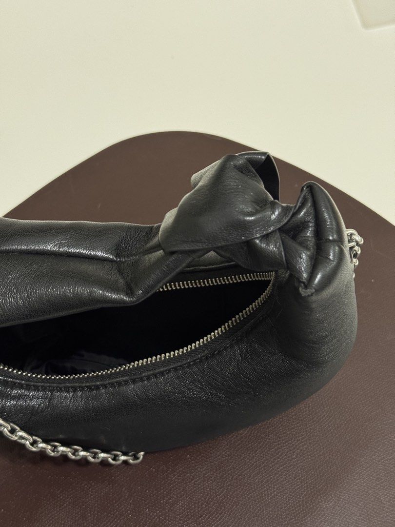 Charles & Keith Black Crescent Hobo Bag with Chain (Category: Shoulder Bags) located in Makati City. Submitted by from.ela (Listing ID 1469481421, Image 3). Description: - Brand: Charles & Keith - Style: Black crescent shoulder bag - Material: Supple faux leather with clean interior lining - Hardware: Silver-tone with top zipper closure - Details: Chic knotted strap on one side - Straps: Includes a removable chunky silver chain strap for versatil