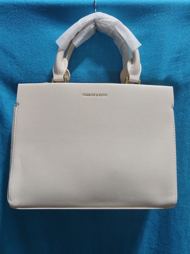 Charles n Keithz Structured Bag (Category: Beach Bags) located in Las Pinas. Submitted by jpmshoppe (Listing ID 1469469869, Image 1). Description: Charles n Keithz Structured Hand Bag with Sling Ivory white in color 3 comparments MPO bag.