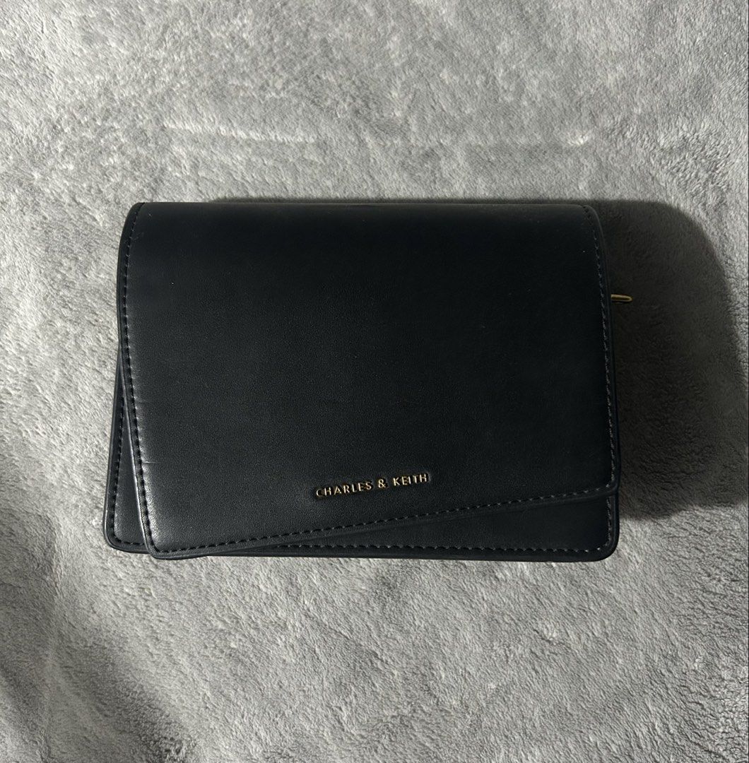 Charles&keith sling bag (Category: Cross-body Bags) located in Quezon City. Submitted by findsbyme_ (Listing ID 1469477520, Image 1). Description: With minor flaws see last photo.