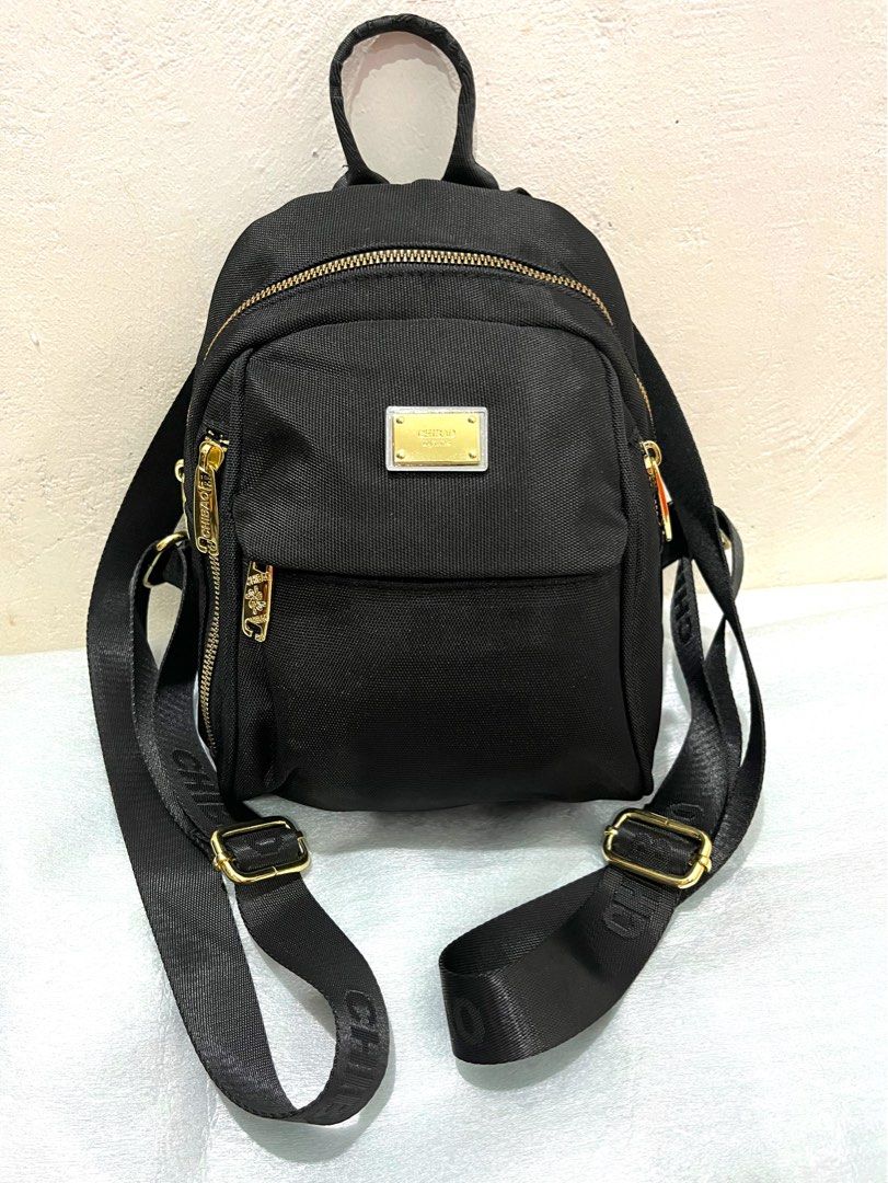 Chibao Black Nylon Mini Backpack with Gold Hardware (Category: Backpacks) located in Talisay. Submitted by cherylu (Listing ID 1469403289, Image 1). Description: - Brand: Chibao - Material: Durable black nylon with luxury gold hardware accents - Straps: Stylish woven 'CHIBAO' lettering straps - Compartments: Secure main zipped compartment, interior zip pocket, and slip pocket - Interior: Branded grey fabric lining - Use: Compact and perfect for e