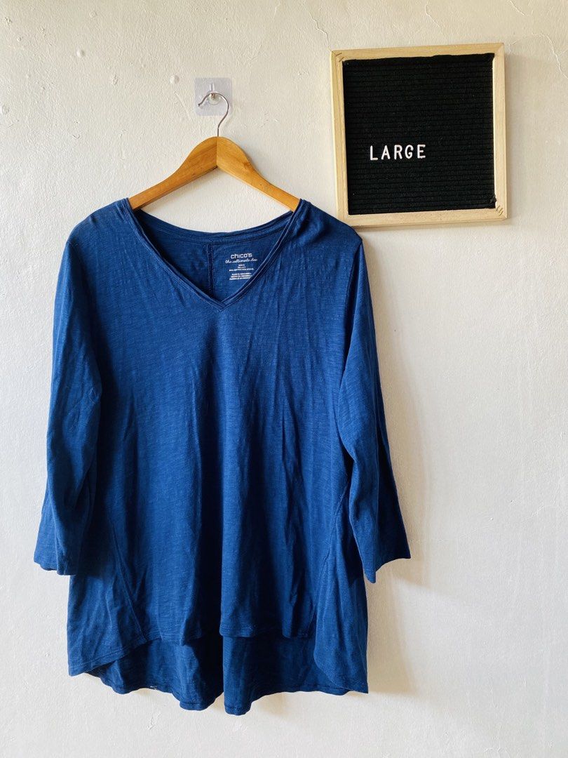 Chico's Blue V-Neck Ultimate Tee Size Large (Category: Shirts) located in Caloocan City. Submitted by lovemyclothes21 (Listing ID 1469407863, Image 1). Description: - Brand/Style: Chico's Ultimate Tee - Color: Blue - Size: 3 (Equivalent to US Large) - Material: 60% Cotton, 40% Modal (super soft & lightweight) - Design: V-neck, 3/4 sleeves, and trendy high-low hem - Fit: Relaxed and comfortable - Perfect everyday basic that easily pairs with jeans