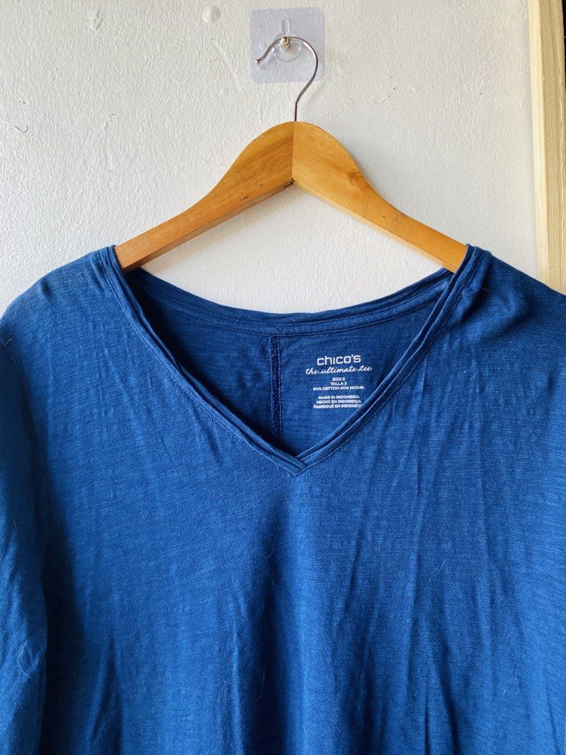 Chico's Blue V-Neck Ultimate Tee Size Large (Category: Shirts) located in Caloocan City. Submitted by lovemyclothes21 (Listing ID 1469407863, Image 3). Description: - Brand/Style: Chico's Ultimate Tee - Color: Blue - Size: 3 (Equivalent to US Large) - Material: 60% Cotton, 40% Modal (super soft & lightweight) - Design: V-neck, 3/4 sleeves, and trendy high-low hem - Fit: Relaxed and comfortable - Perfect everyday basic that easily pairs with jeans