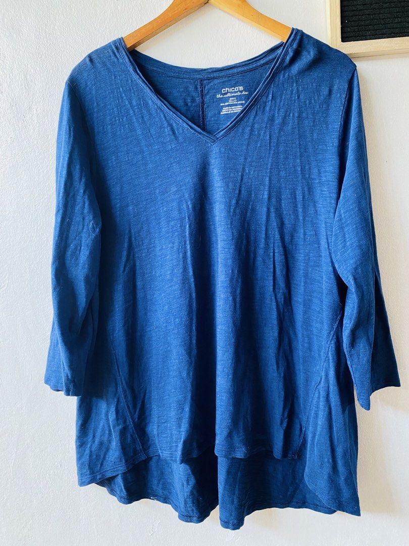 Chico's Blue V-Neck Ultimate Tee Size Large (Category: Shirts) located in Caloocan City. Submitted by lovemyclothes21 (Listing ID 1469407863, Image 2). Description: - Brand/Style: Chico's Ultimate Tee - Color: Blue - Size: 3 (Equivalent to US Large) - Material: 60% Cotton, 40% Modal (super soft & lightweight) - Design: V-neck, 3/4 sleeves, and trendy high-low hem - Fit: Relaxed and comfortable - Perfect everyday basic that easily pairs with jeans