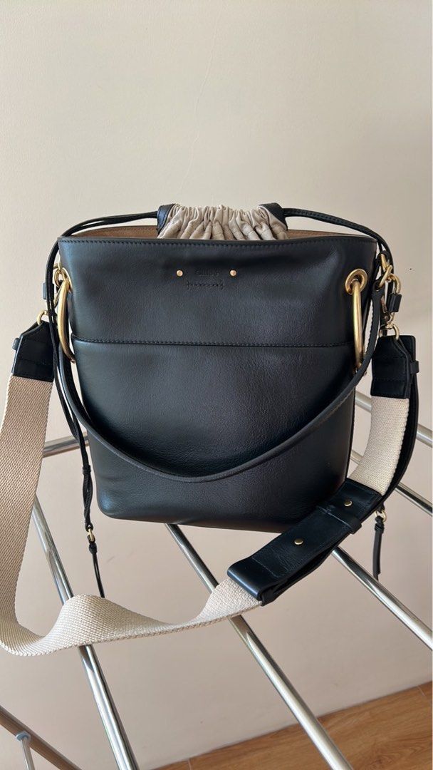 Chloé Black Leather Bucket Bag (Category: Luxury Bags & Wallets) located in Las Pinas. Submitted by emwcuabc (Listing ID 1469507227, Image 1). Description: - Color & Material: Black leather body with cream fabric drawstring pouch and beige interior lining - Hardware: Premium gold-tone rings on the sides with zero scuffs - Straps: Includes both a thick neutral canvas shoulder strap and sturdy leather handles - Interior: Features a secure zippered 