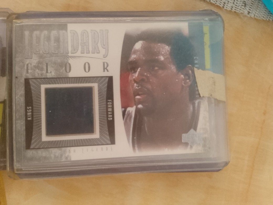 Chris Webber (Category: Raw Singles) located in San Juan City. Submitted by jim.jim7 (Listing ID 1469412671, Image 1). Description: - Player: Chris Webber (Sacramento Kings) - Set: Legendary Floor - Special Feature: Embedded piece of actual game floor - Condition/Protection: Stored in a clear protective top loader case - Ideal for: NBA memorabilia and basketball card collectors.