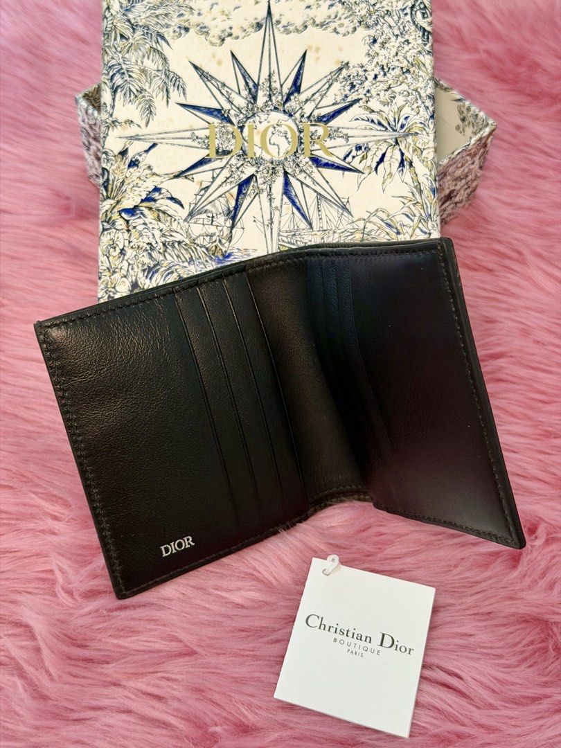 Christian Dior Black Diamond Pattern Wallet With Box (Category: Luxury Bags & Wallets) located in Caloocan City. Submitted by ghlvllrmn391585 (Listing ID 1469427596, Image 2). Description: - Brand: Christian Dior - Style: Bifold wallet - Color: Classic black with geometric diamond pattern - Hardware: Silver DIOR logo on the front lower corner - Interior: Smooth black leather with multiple card slots and subtle branding - Inclusions: Original Chri