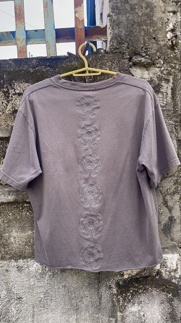 Chrome Hearts Embroidered Horseshoe T-Shirt Grey (Category: Tshirts & Polo Shirts ) located in Balanga. Submitted by death_vintage (Listing ID 1469475708, Image 3). Description: - Brand: Chrome Hearts - Color: Washed grey with vintage faded wash - Material: Heavyweight cotton - Design: Small embroidered horseshoe logo on left chest - Back Detail: Column of stacked horseshoe logos down the spine - Cut: Crew neck, short sleeves, and raw hem at the 