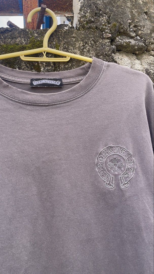 Chrome Hearts Embroidered Horseshoe T-Shirt Grey (Category: Tshirts & Polo Shirts ) located in Balanga. Submitted by death_vintage (Listing ID 1469475708, Image 2). Description: - Brand: Chrome Hearts - Color: Washed grey with vintage faded wash - Material: Heavyweight cotton - Design: Small embroidered horseshoe logo on left chest - Back Detail: Column of stacked horseshoe logos down the spine - Cut: Crew neck, short sleeves, and raw hem at the 