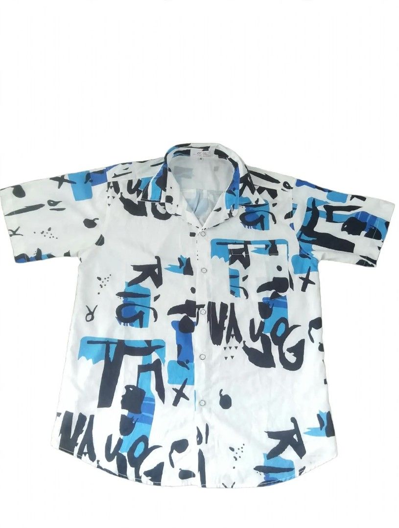 C.K Sleeves (Category: Coats, Jackets and Outerwear) located in Roxas City. Submitted by xanshopz.5800 (Listing ID 1469409271, Image 2). Description: 📝 Product Description Item: Men's Short-Sleeve Printed Shirt Brand: C.K. — Original Design Size: Medium (M) Colorway: Off white base with bright blue and bold black abstract lettering graffiti style print Cut: Relaxed, casual fit, standard collar, button-front placket, short sleeves Style: Modern s