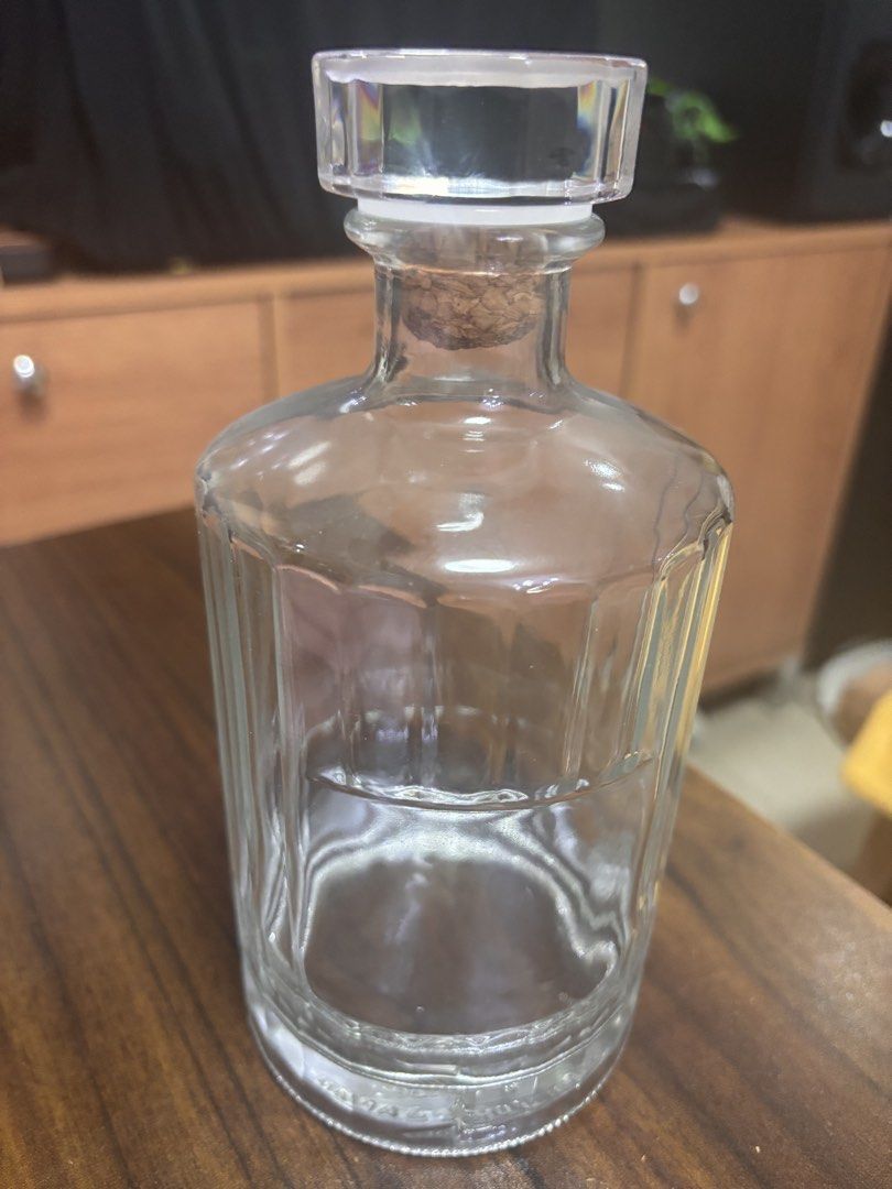 Clear Glass Decanter Bottle with Cork Stopper (Category: Vases & Decorative Bowls) located in Caloocan City. Submitted by pnkcshmr (Listing ID 1469505870, Image 1). Description: - Elegant clear glass decanter with panelled sides - Secure cork seal and geometric glass stopper - Heavy base with decorative embossed patterns - Perfect for whiskey, homemade spirits, or oils - Sturdy design ideal for bar carts or display.