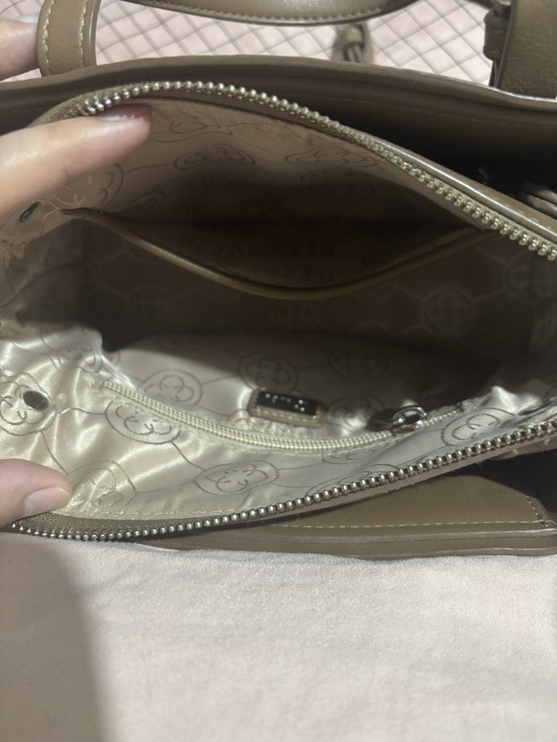 CLN Brown Monogram Handbag with Charm (Category: Luxury Bags & Wallets) located in Caloocan City. Submitted by alnair7 (Listing ID 1469476259, Image 3). Description: - Brand: CLN - Color: Brown with debossed all-over monogram pattern - Hardware: Silver-tone with top handles and matching luggage tag charm - Closure: Zip closure - Interior: Fabric lining with CLN logo pattern, multiple compartments, and a zip pocket - Condition: Minor peeling on th