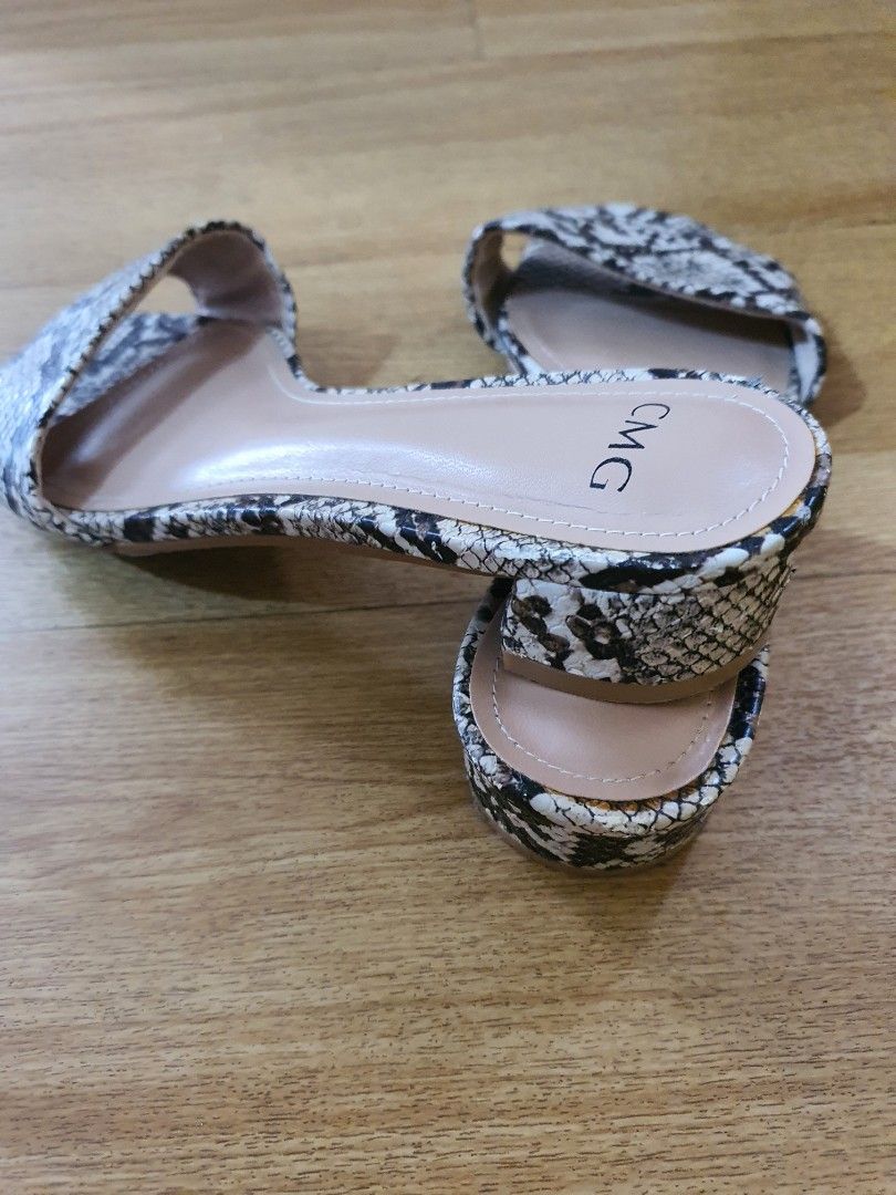 CMG Snake Print Heels (Category: Heels) located in Santa Rosa. Submitted by regcruz (Listing ID 1469398339, Image 3). Description: - Brand: CMG - Style: Slip-on slide heels with open toe - Design: Snake print on straps and low block heel - Color: Neutral nude tones that match any outfit - Comfort: Low block heel for easy, all-day walking - Condition: Clean insoles and soles, well-maintained.