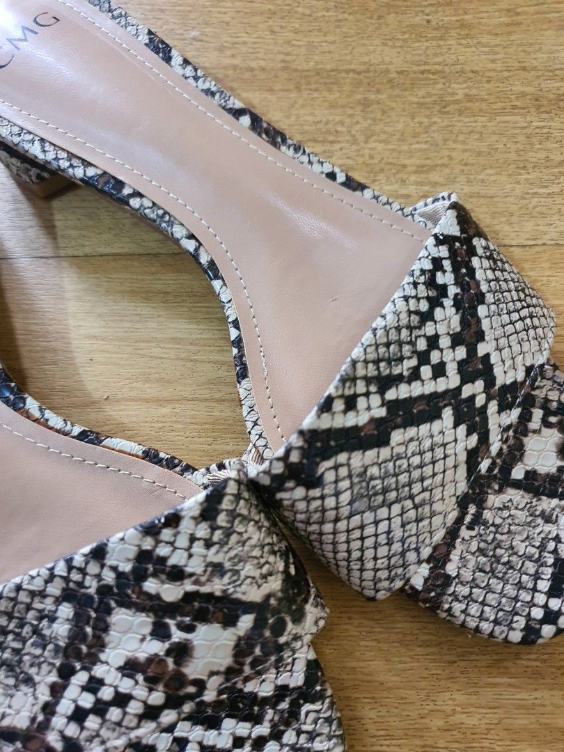 CMG Snake Print Heels (Category: Heels) located in Santa Rosa. Submitted by regcruz (Listing ID 1469398339, Image 2). Description: - Brand: CMG - Style: Slip-on slide heels with open toe - Design: Snake print on straps and low block heel - Color: Neutral nude tones that match any outfit - Comfort: Low block heel for easy, all-day walking - Condition: Clean insoles and soles, well-maintained.