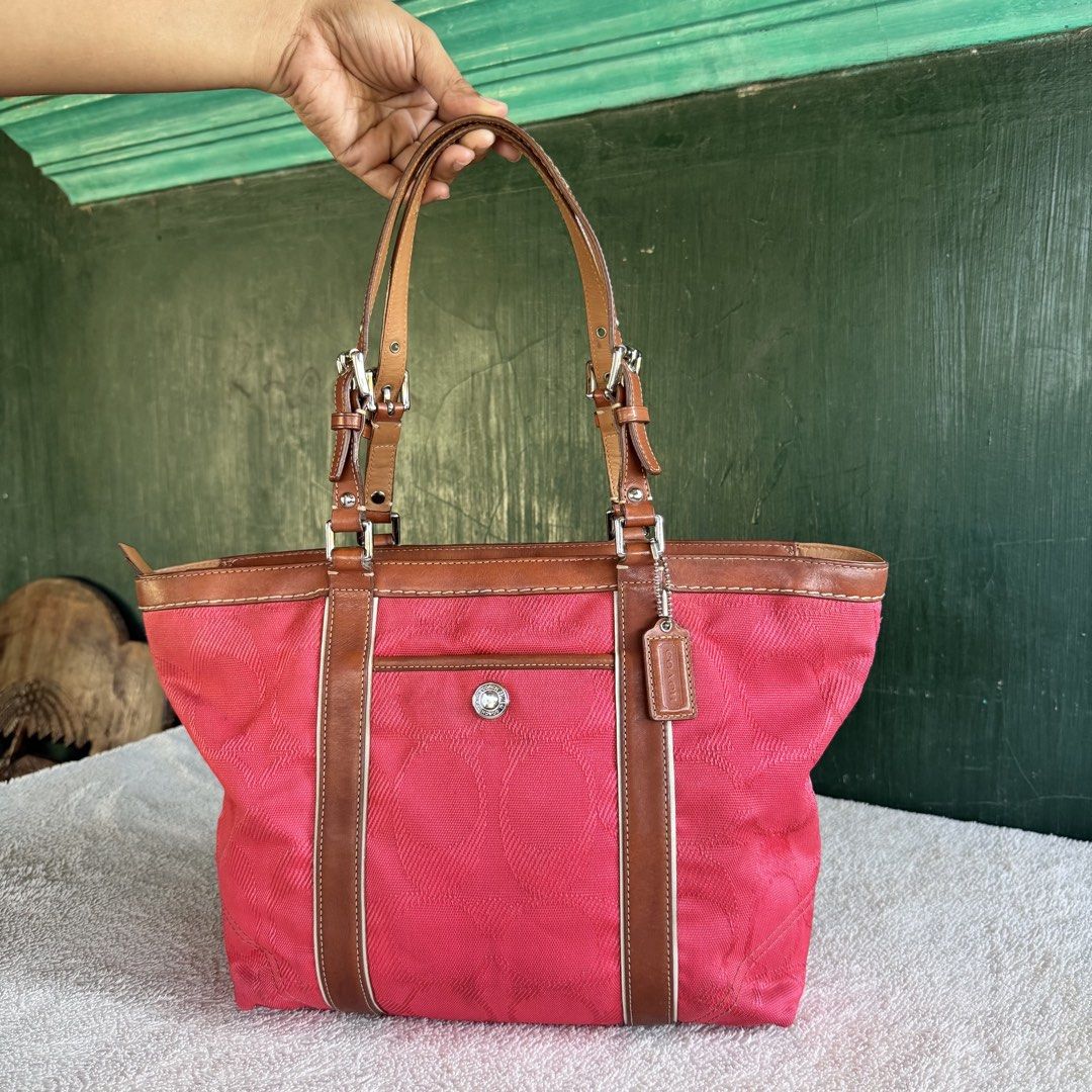 Coach Gallery Medium Tote (Category: Luxury Bags & Wallets) located in Vigan. Submitted by chiyannav (Listing ID 1469430689, Image 2). Description: • Brand & Model: Coach Gallery Tote / Shoulder Bag (A0920-F13560) • Color / Material: Coral pink signature C fabric/canvas exterior with brown leather trim and handles • Features: Silver-tone or gold-tone hardware, front exterior pocket with a snap/turn-lock closure, and the classic Coach leather hang