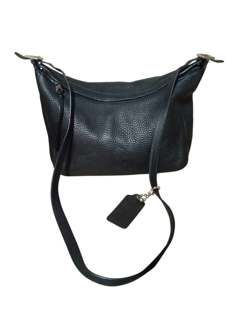 Coach Black Leather Pebbled Shoulder Bag with Tag (Category: Luxury Bags & Wallets) located in Urdaneta. Submitted by assortedprelovedd (Listing ID 1469461676, Image 1). Description: - Authentic Coach shoulder bag in black pebbled leather - Secure zip top closure - Adjustable strap for shoulder or crossbody wear - Includes matching leather hangtag on a beaded chain - Sleek silver-tone hardware accents - Spacious interior fits daily essentials lik